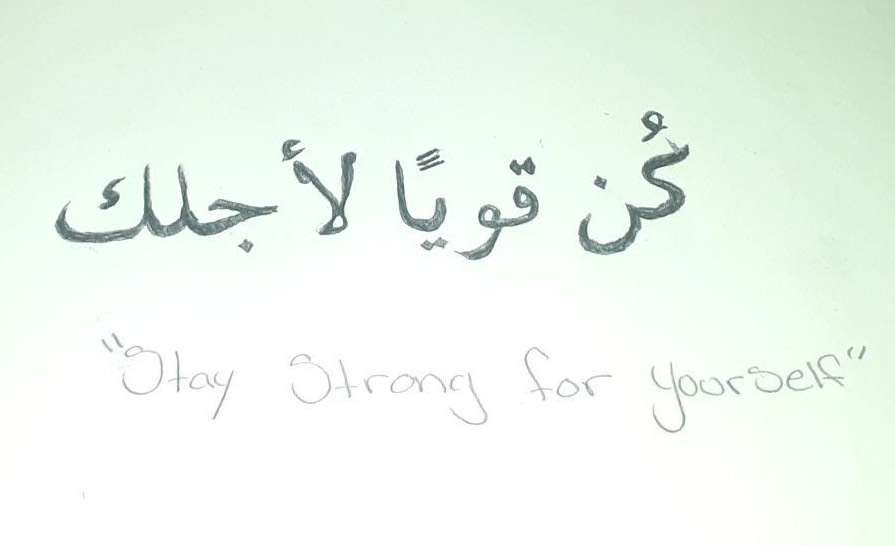 Arabic script in pencil with the English translation below, "Stay Strong for Yourself" 