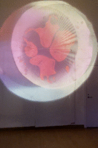 Overlapped circle projections with red liquid blob in the center, rotating